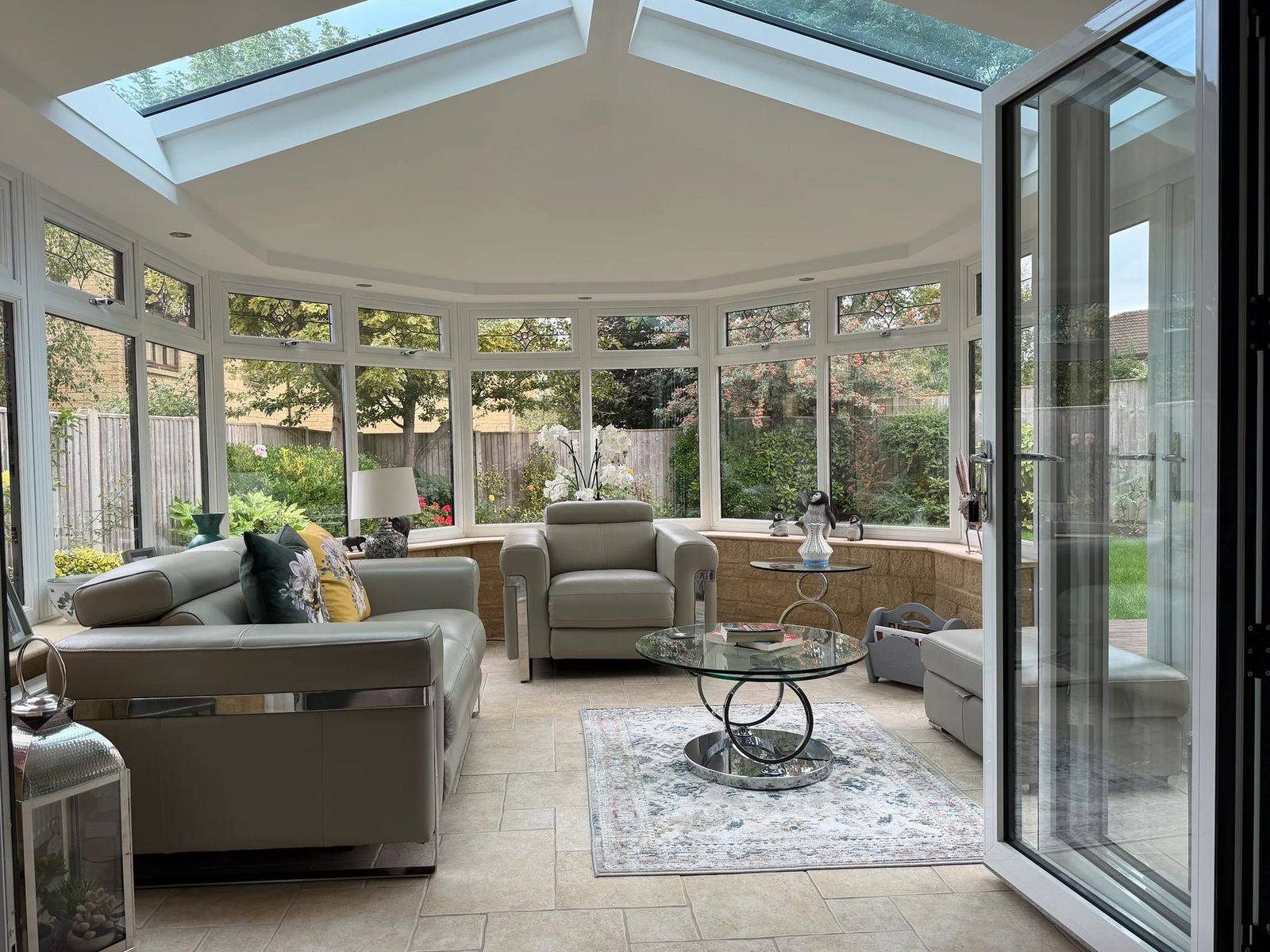 Bright conservatory interior in Cheltenham under a new Ultraroof with glazed panels and bi-fold doors