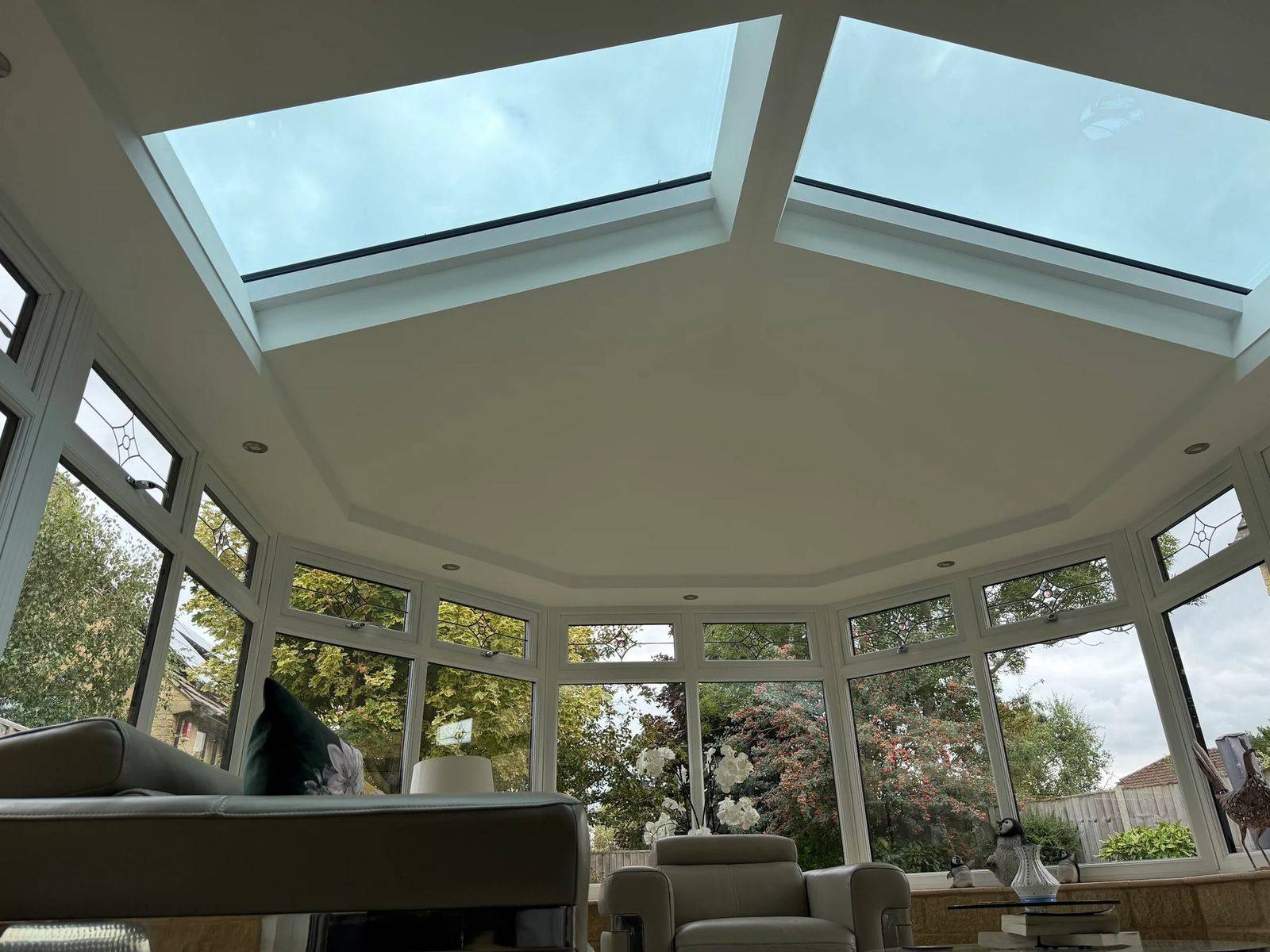 Vaulted plastered conservatory ceiling with spotlights and glazed roof panels under an Ultraroof