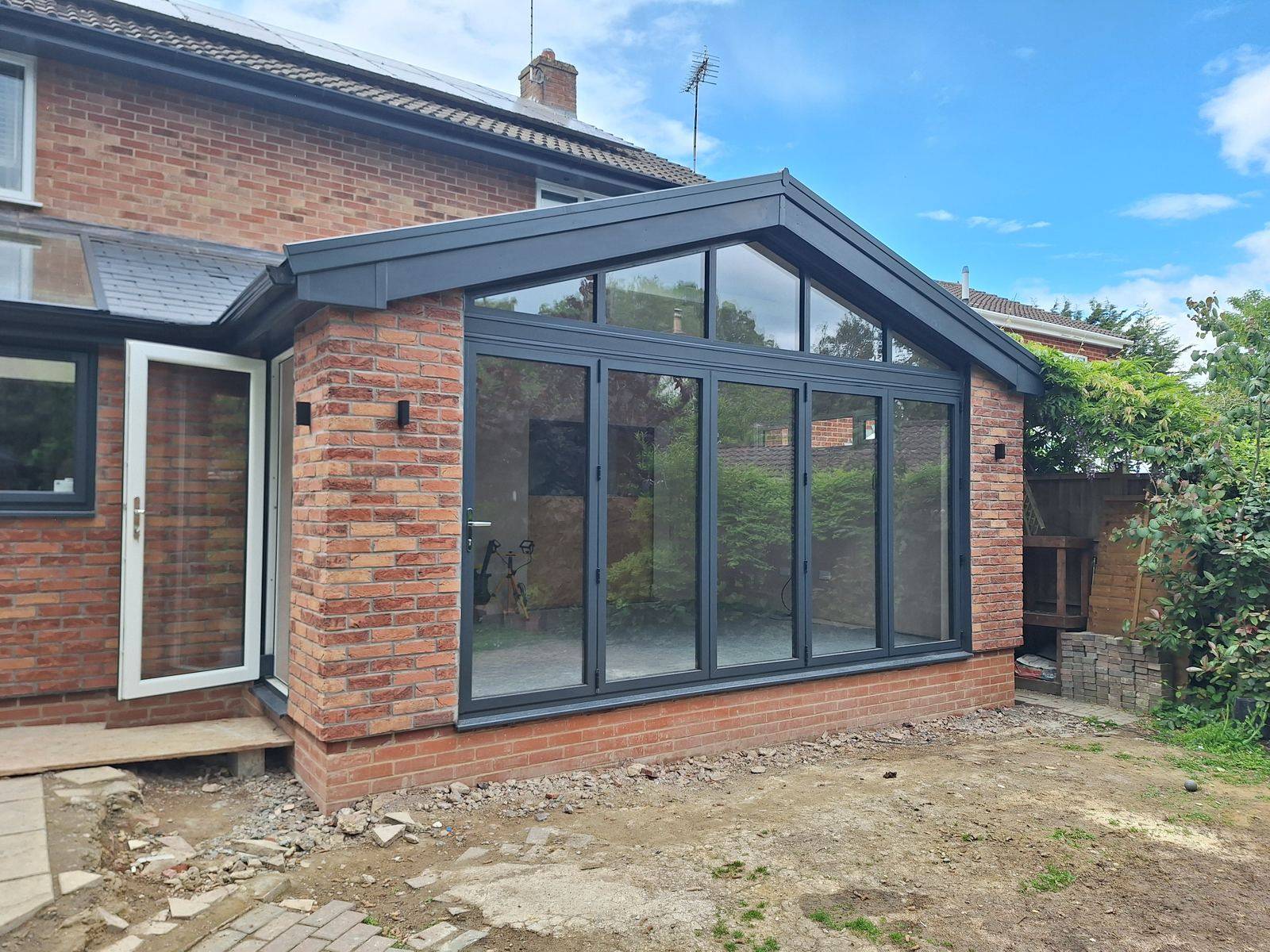 Brick-finished rear extension in Gloucester with an anthracite glazed gable and side door